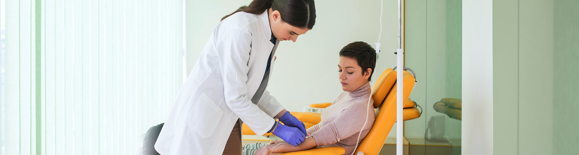 staff assisting patient with dextrose