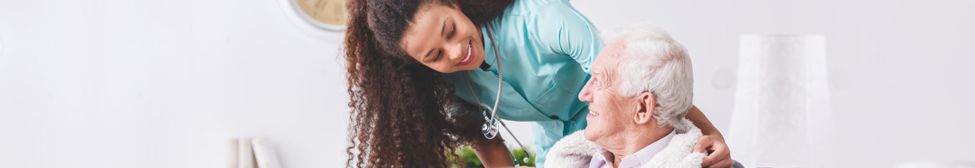 nurse and elder man smiling