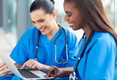 Happy nurse workers using laptop