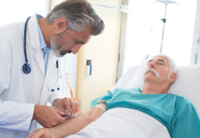 doctor collecting senior patients blood for test 